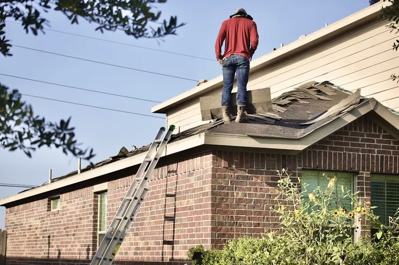 Professional roofer working on a residential roof in Canton Center